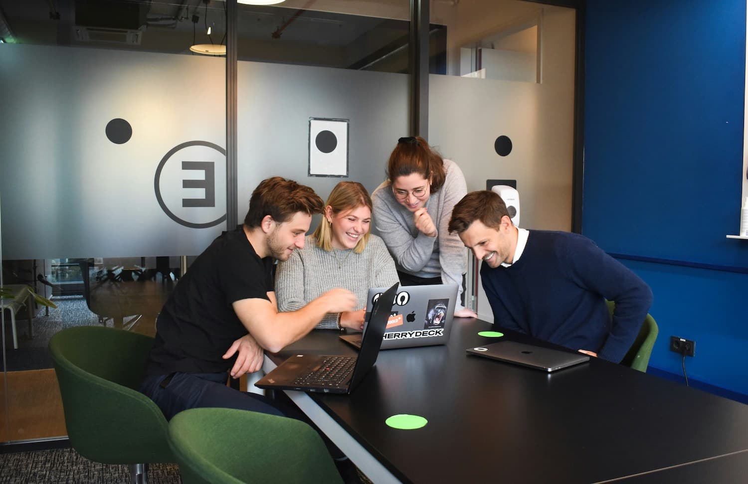 The Vectorox team collaborating around a laptop